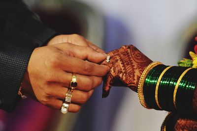 Midsection of couple holding hands