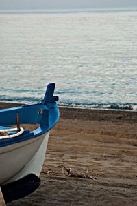 Boat on beach against sky