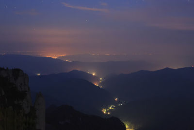 Scenic view of silhouette mountains against sky at sunset