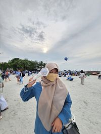 Rear view of woman standing on beach