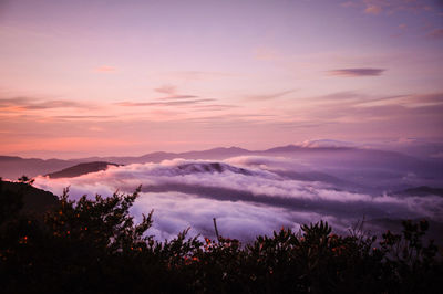 Scenic view of silhouette mountains against sky at sunset