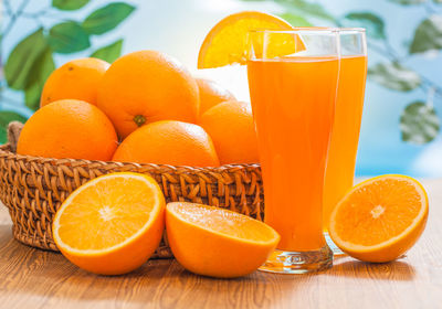 Orange fruits in glass on table