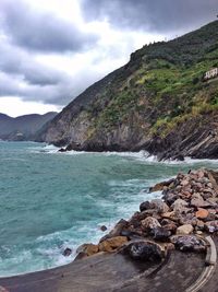 Scenic view of sea and mountains against sky