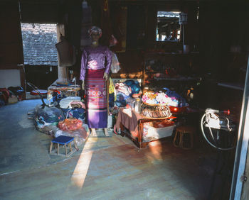 People at illuminated market stall at night