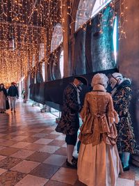 People walking in corridor of building