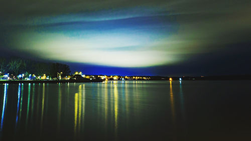 Scenic view of lake against sky at night