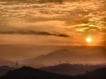 Scenic view of mountains against sky at sunset