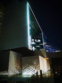 Illuminated cityscape against sky at night