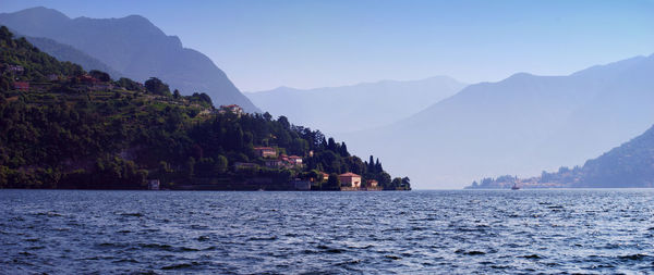 Scenic view of sea and mountains against sky