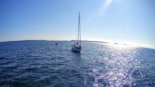 Sailboat sailing on sea against sky