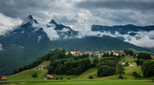 Scenic view of trees and mountains against sky