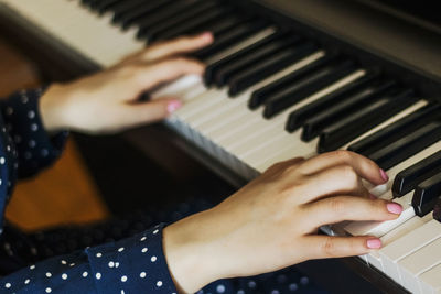 Midsection of man playing piano