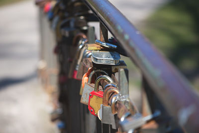 Close-up of padlocks hanging on railing