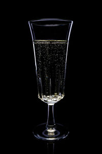 Close-up of wine glass against black background