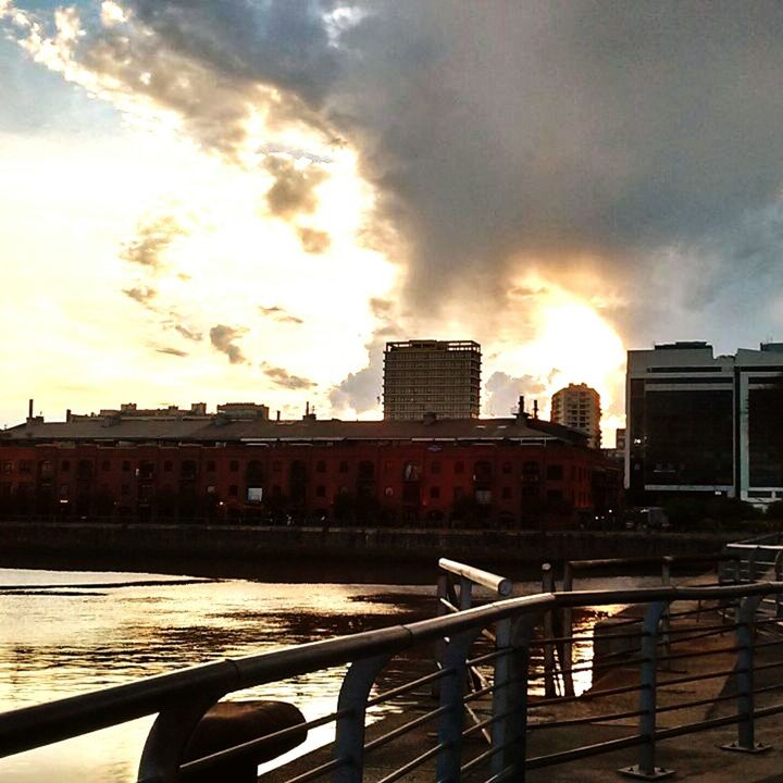 VIEW OF CITYSCAPE AGAINST SKY DURING SUNSET