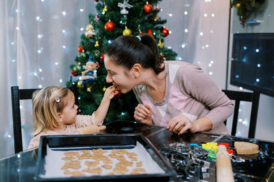 Side view of young woman preparing food at home