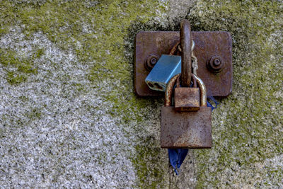Close-up of padlock on rusty metal