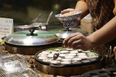 Cropped hand of man preparing food