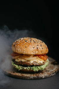 Close-up of burger against black background