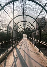 View of footbridge through chainlink fence