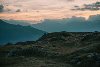 Scenic view of mountains against sky at sunset