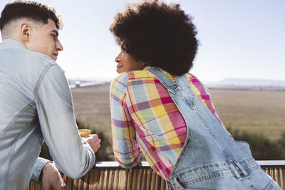 Young couple looking at each other on balcony