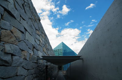 Low angle view of building against cloudy sky