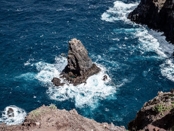 High angle view of rock formation in sea