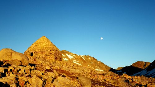 View of desert against clear blue sky