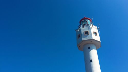 Low angle view of lighthouse against blue sky