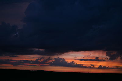 Silhouette of landscape against sky at sunset