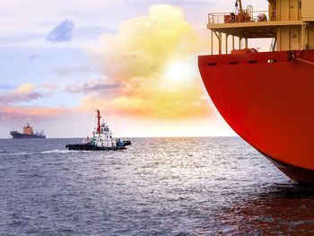 Cropped image of ship on sea against cloudy sky