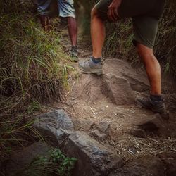 Low section of men standing on grass