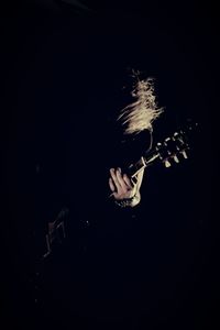 Man playing guitar at night