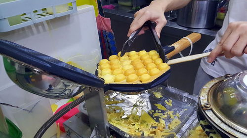 Close-up of man working in tray