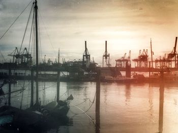 Boats moored at harbor against sky