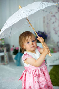 Portrait of cute girl holding baby