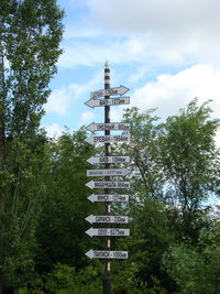 Low angle view of information sign against sky