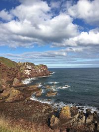 Scenic view of sea against cloudy sky