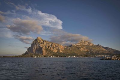 Scenic view of sea and mountains against sky