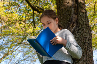 Young woman reading book