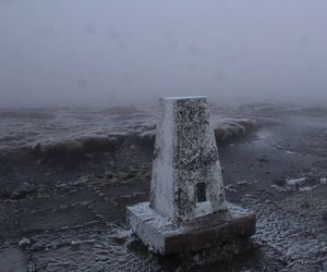 Close-up of snow on sea against sky