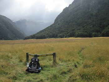 Scenic view of land and mountains against sky