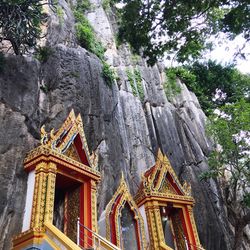 Low angle view of entrance of temple against rock formation