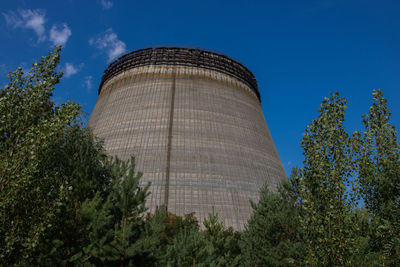 Low angle view of water tower against blue sky