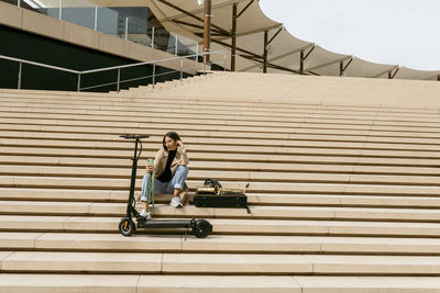 Woman sitting on staircase