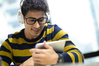 Portrait of young man using mobile phone