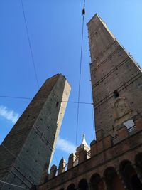 Low angle view of buildings against clear blue sky