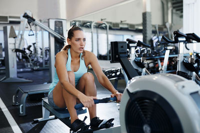 Young woman exercising at gym