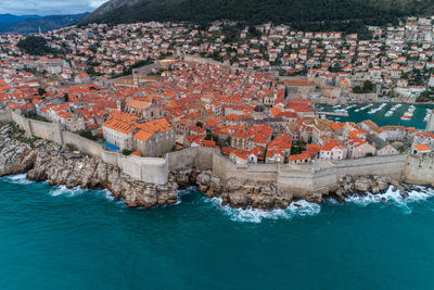 High angle view of townscape by sea